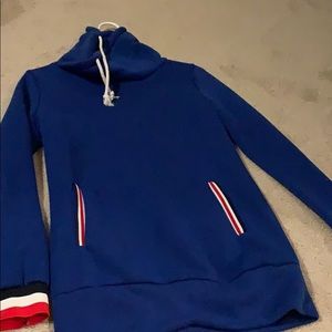 A blue sweatshirt with red, black and white detail